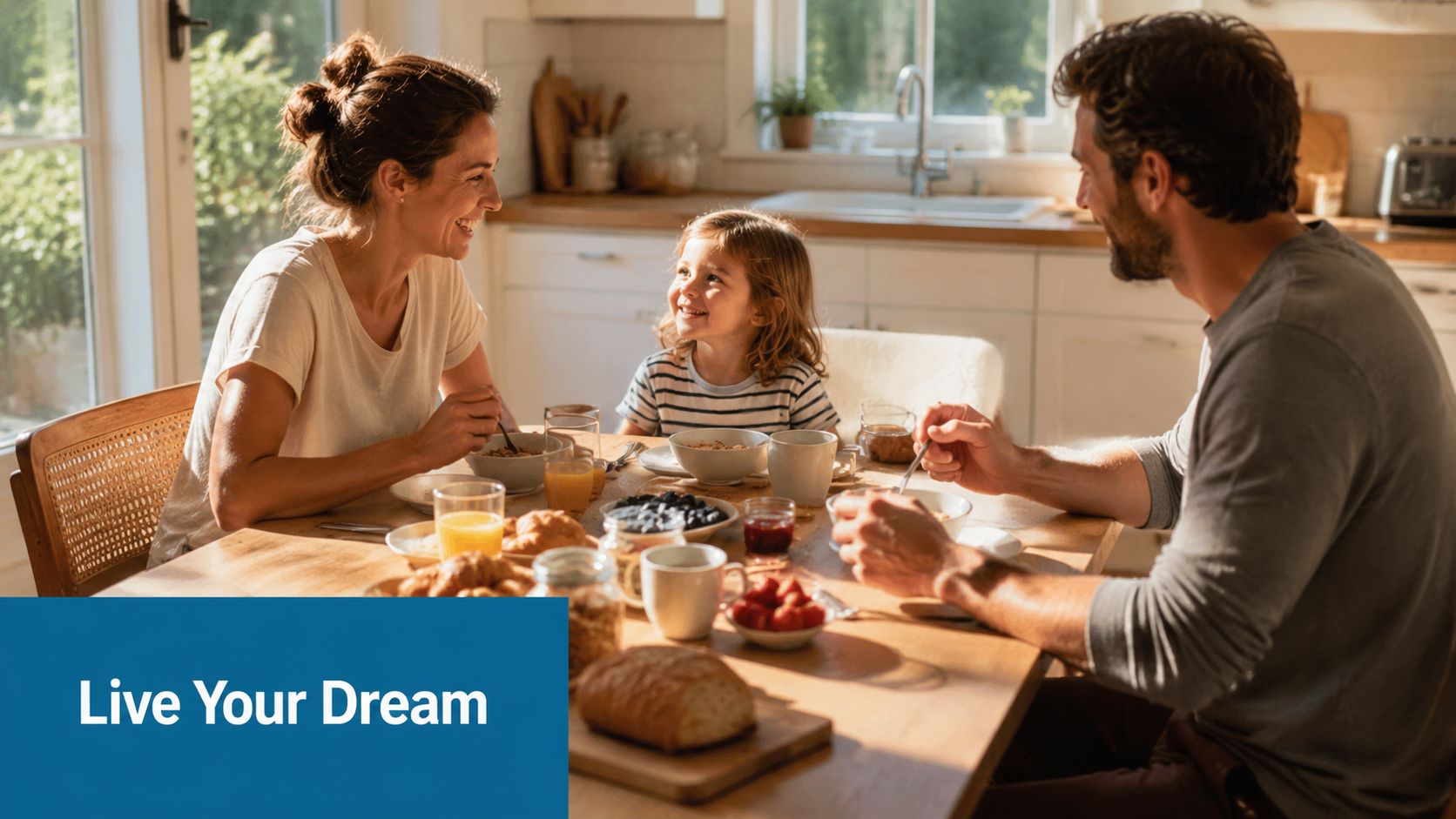 A happy family of three having a sunny morning breakfast together in a bright modern kitchen.