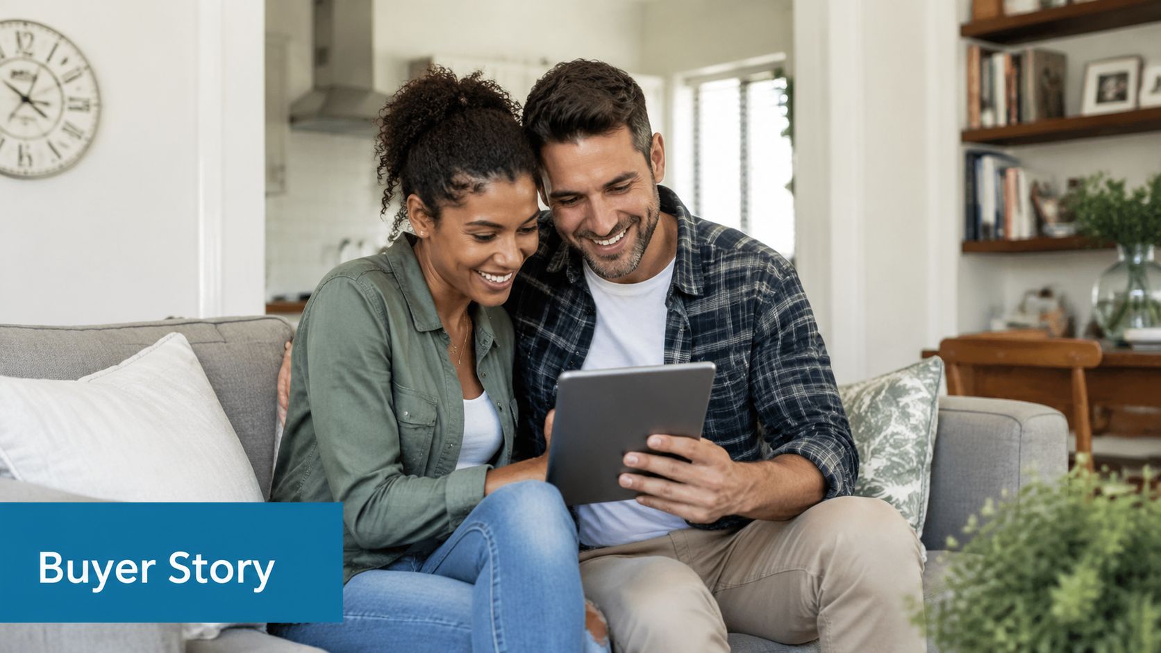 A happy couple sitting on a sofa while browsing real estate listings on a digital tablet together.